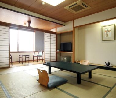 Traditional tatami room with low table, shoji screens and window seating at Miyajima Hotel Makoto Hiroshima