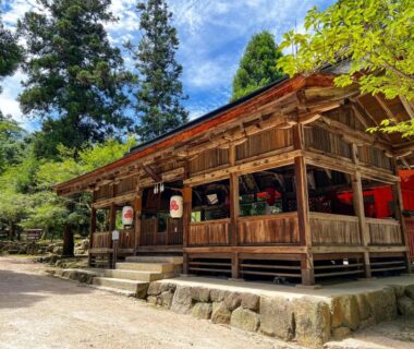 Traditional wooden pavilion with red lanterns at Miyajima Morinoyado, forested area of Hiroshima, Chūgoku