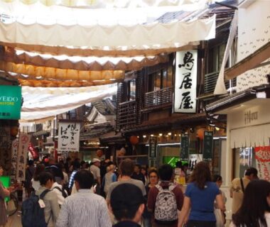 Crowded covered shopping arcade with wooden storefronts near Miyajima Shiro, Hiroshima, Chūgoku region