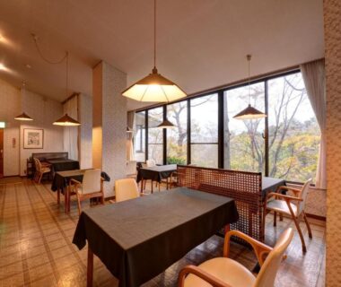 Dining area with tables, wooden chairs and pendant lights at Mizu no Kaori, Kanagawa