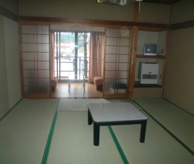 Traditional tatami room with low table, shoji screens and balcony at Mizubaso in Gifu