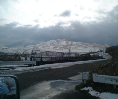 Snow-covered hills and roadside with guardrail under cloudy sky near Mizubaso, Gifu, Chūbu