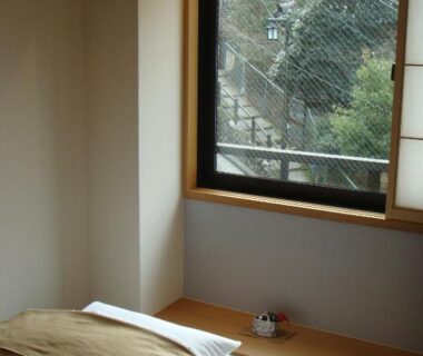 Tatami room with futon and shoji screens at Mizuhasou, Hiroshima