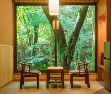 Tatami seating with low chairs and large window looking out to forest at Mizumari, Shizuoka
