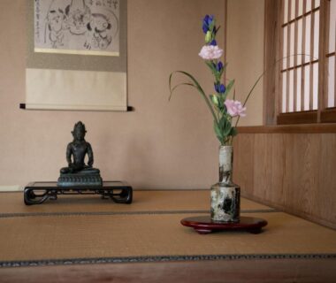 Tatami alcove with Buddha statue, hanging scroll, shoji screens, and floral ikebana at Mizuno Ryokan in Saga