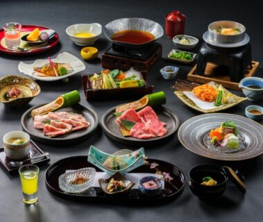 Assorted Japanese dishes on lacquer trays with a small tabletop hot pot at Mizunoto, Kanagawa