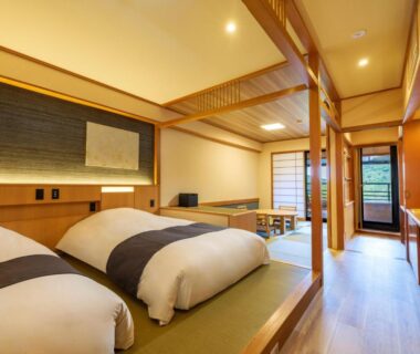 Traditional tatami room with two low beds, shoji screens and wooden interior at Mizunoto in Kanagawa