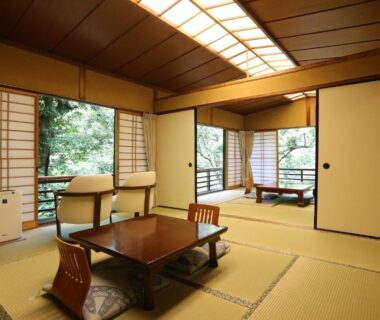 Traditional tatami room with low table, shoji screens and garden view at Momijiya Annex in Kyoto, Kansai