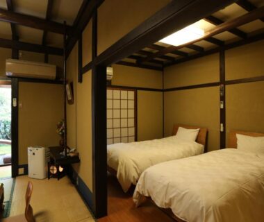 Tatami room with twin beds, shoji screens and garden view at Momijiya Annex Kyoto