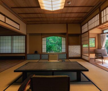 Spacious tatami room with low table, shoji screens and garden view at Monjusou Shourotei in Kyoto