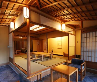 Traditional tatami room with low table, shoji screens and wooden ceiling at Monjusou Shourotei Kyoto