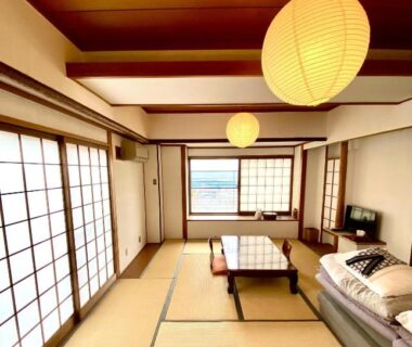 Tatami room with low table, shoji screens and hanging lanterns at Monzen Okagero, Nara, Kansai