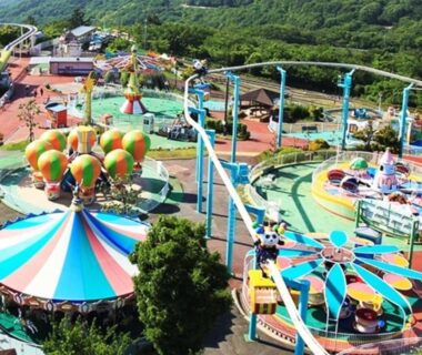 Colorful amusement park rides and roller coaster near Monzen Okagero in Nara, Kansai