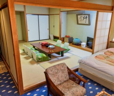 Spacious mixed tatami and Western room with low table, futon mattress, shoji screens at Mori no RyoTei in Fukushima