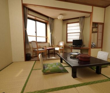 Tatami room with low table, cushions, seating area and windows at Mori no RyoTei Mount Bandai, Fukushima