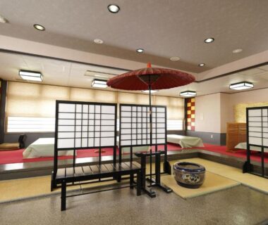 Traditional tatami room with shoji screens, low tables and decorative parasol at Mori no RyoTei in Fukushima