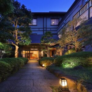 Stone path and lanterns leading to Moritaya entrance, manicured garden at dusk in Fukushima Tōhoku