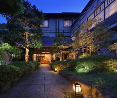 Stone path and lanterns leading to Moritaya entrance, manicured garden at dusk in Fukushima Tōhoku