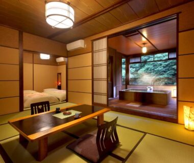 Traditional tatami room with low table, zabuton chairs and wooden tub overlooking garden at Moritaya, Fukushima
