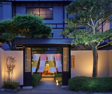 Evening-lit noren and landscaped approach to Moritaya ryokan in Fukushima, Tōhoku