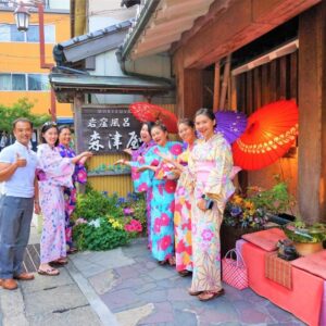 Group wearing yukata outside Morizuya entrance with lanterns in Hyōgo Japan
