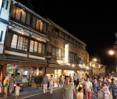Bustling night street with people in yukata outside traditional ryokan Morizuya in Hyōgo, Kansai