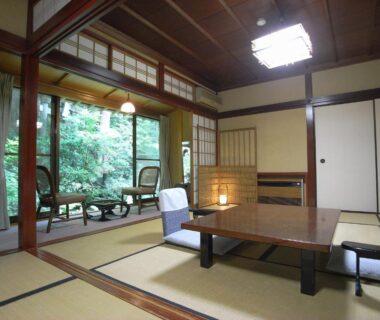 Traditional tatami room with low table, shoji screens and garden-facing veranda at Motoyu Ishiya in Ishikawa Chūbu