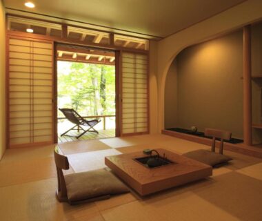 Traditional tatami room with low table, shoji screens and greenery outside at Mozumo (Adult Only), Chūbu Gifu Japan