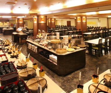 Large buffet dining room with arranged trays at Mt Fuji Hanayagi no Sho Keizan in Yamanashi