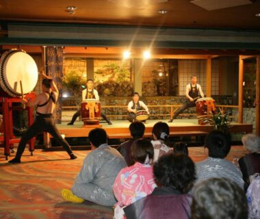 Audience watching taiko drummers performing on stage at Mt Fuji Hanayagi no Sho Keizan in Yamanashi