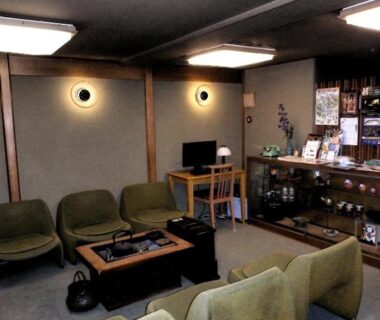 Low green armchairs and coffee table in a calm lounge at Murataya, Ishikawa