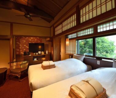 Twin beds on tatami floor with shoji screens and garden view at Muromachi Yutone Kyokoyado Kyoto