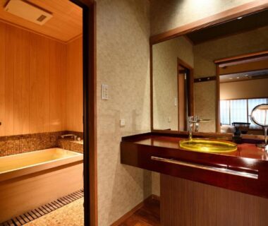 Washroom with wooden soaking tub, vanity sink and shoji window at Muromachi Yutone Kyokoyado Kyoto