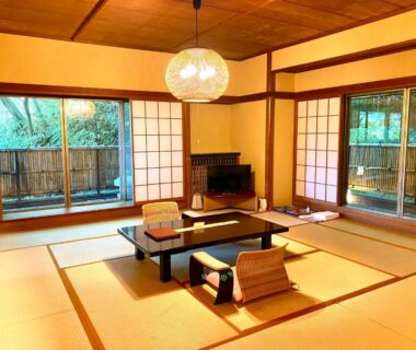 Traditional tatami room with low table, shoji screens and veranda at Musashino Bekkan, Kanagawa