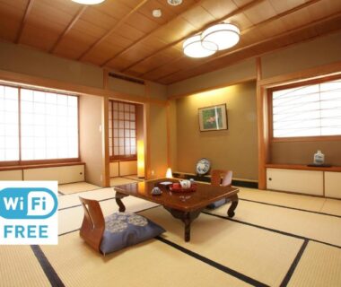 Traditional tatami room with low table, zabuton cushions, shoji screens and visible free WiFi sign