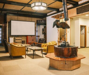 Central irori hearth and sofas in ryokan lounge at Myoko Tsubame Iwatoya Niigata