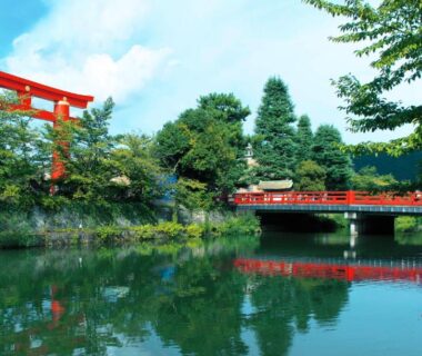 Red torii and bridge reflected in calm pond at NAGOMI Kyoto Okazaki, Kyoto Kansai