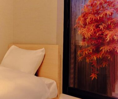 Western-style bed beside window with red maple outside, NEW Hotel Komugi Skytree, Tokyo Japan