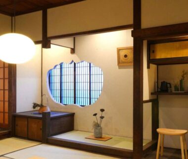 Traditional tatami room with shoji screens, round window, wooden beams and alcove at NIPPONIA HOTEL Takehara Saltworks Town, Hiroshima