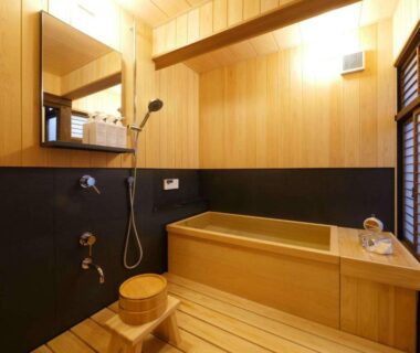 Indoor wooden ofuro with stool and handheld shower at NIPPONIA HOTEL Takehara Saltworks Town in Hiroshima