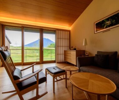 Wooden lounge with low tables, sofa and shoji screens at NISEKO Inn of Youtei Raku Suisan, Hokkaidō