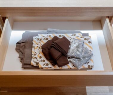 Neatly folded yukata and robes in a wooden drawer at NISHIYAMA RYOKAN, Kyoto
