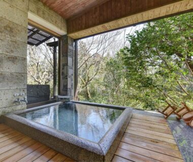 Stone onsen bath on wooden deck overlooking forest at Nagataki, Gifu, Chūbu, Japan