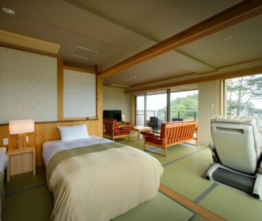Spacious tatami room with twin beds, lounge seating and greenery view at Nagisatei Taroan, Iwate Tōhoku