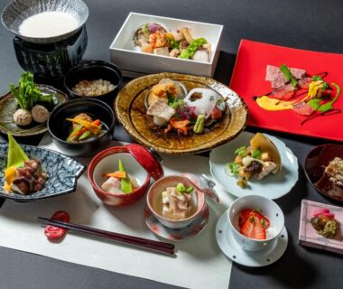 Assorted multi-course Japanese dishes on lacquer tray with chopsticks at Nagominoyado Hanagokoro Kanagawa