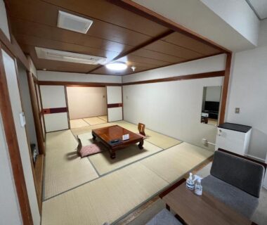 Tatami room with low table, cushions and seating area at Nakamuraya Ryokan in Hokkaidō, Japan