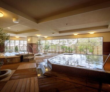 Indoor communal onsen baths with wooden deck and garden view at Nakanobo Zuien, Hyōgo, Kansai