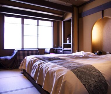 Twin beds on tatami floor with shoji window and alcove at Nakaya Ryokan in Gunma, Kantō Japan