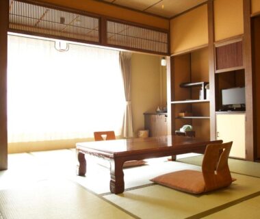 Bright tatami room with low table and floor cushions at Nakaya Ryokan in Gunma, Kantō