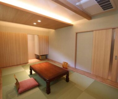 Traditional tatami room with low wooden table and floor cushions at Nakaya Ryokan, Gunma Kanto